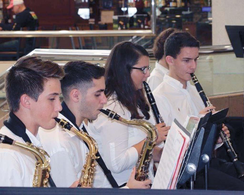 Male & female students playing trumpet